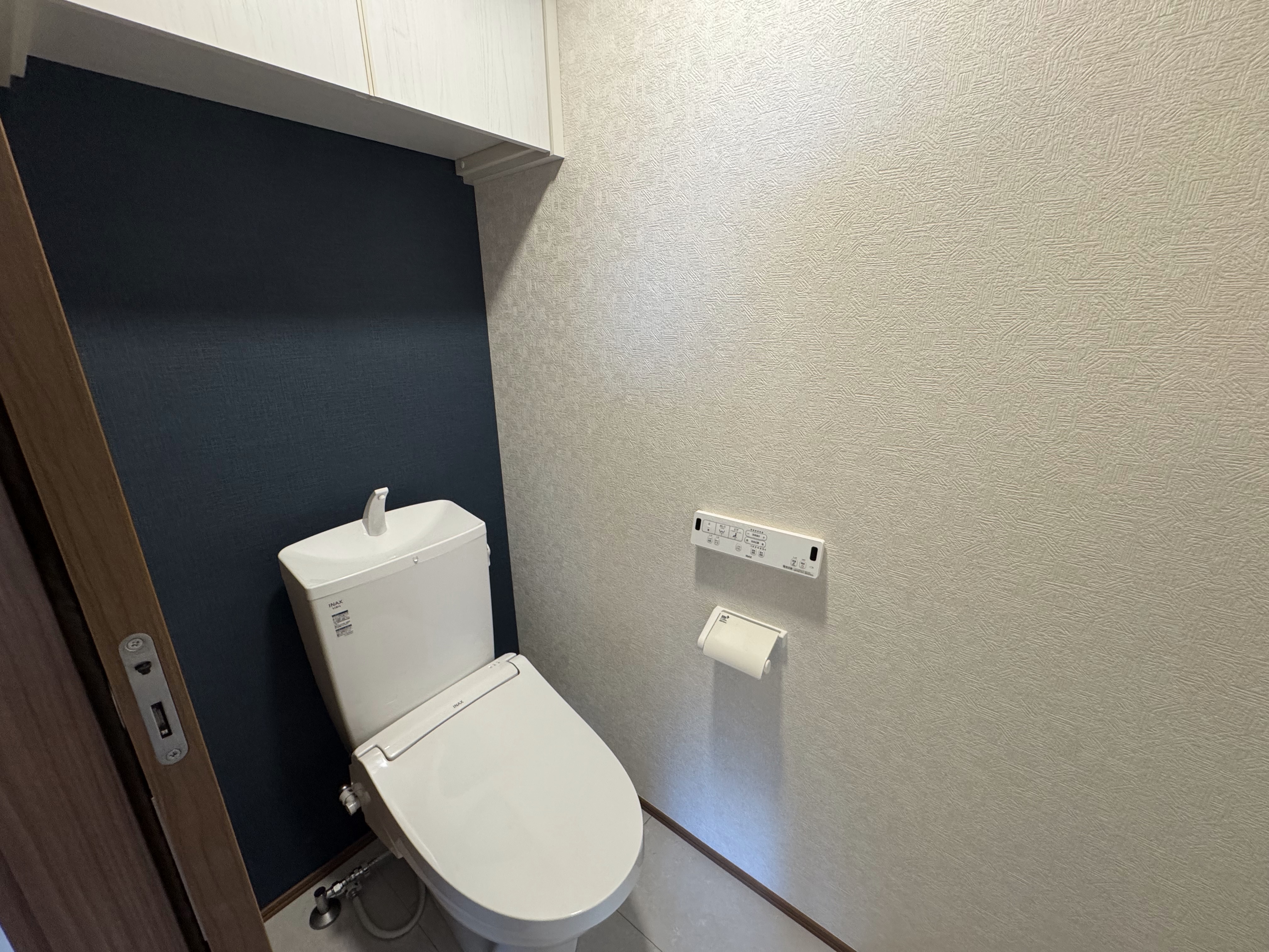 上部に収納棚のあるシャワートイレ付きのトイレスペース
 loading=