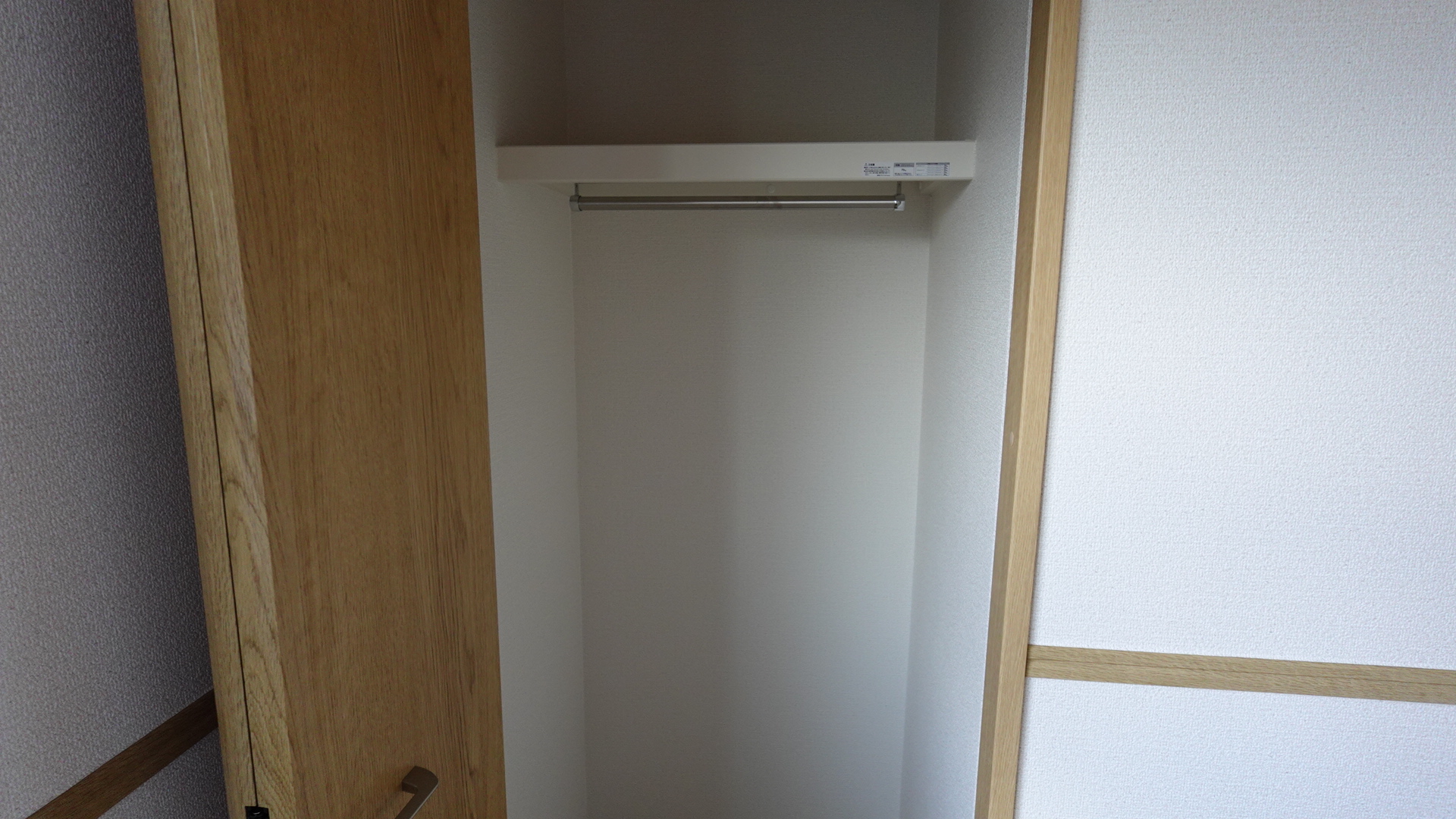 収納棚とハンガーパイプのある収納スペース loading=